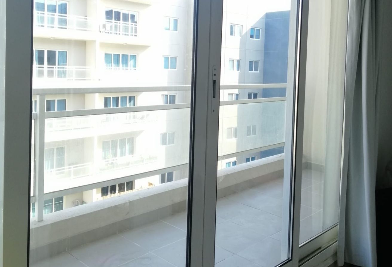 Studio apartment for sale in Tower 21 Al Reef Downtown Abu Dhabi with balcony, rented until 2025, strong ROI investment