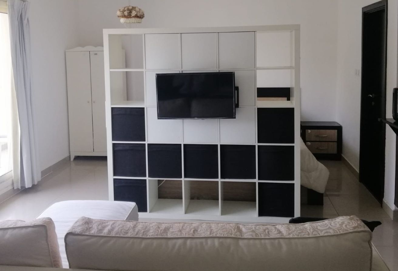 Affordable studio apartment for sale in Tower 21 Al Reef Downtown Abu Dhabi with balcony, parking, and shared poo