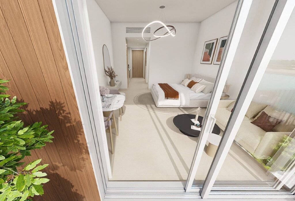 Top-floor studio apartment for sale in Gardenia Bay Yas Island Abu Dhabi with balcony street view, modern layout, and strong ROI investment.